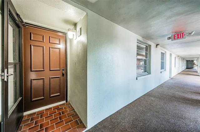 a view of an empty room and wooden floor