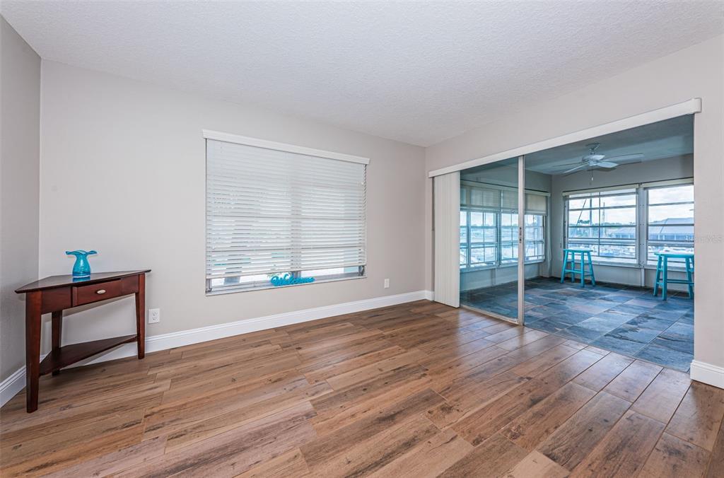 5157 Silent Loop, Unit 301 New Port Richey, FL 34652 - Photo 15 of 71 an empty room with wooden floor and windows