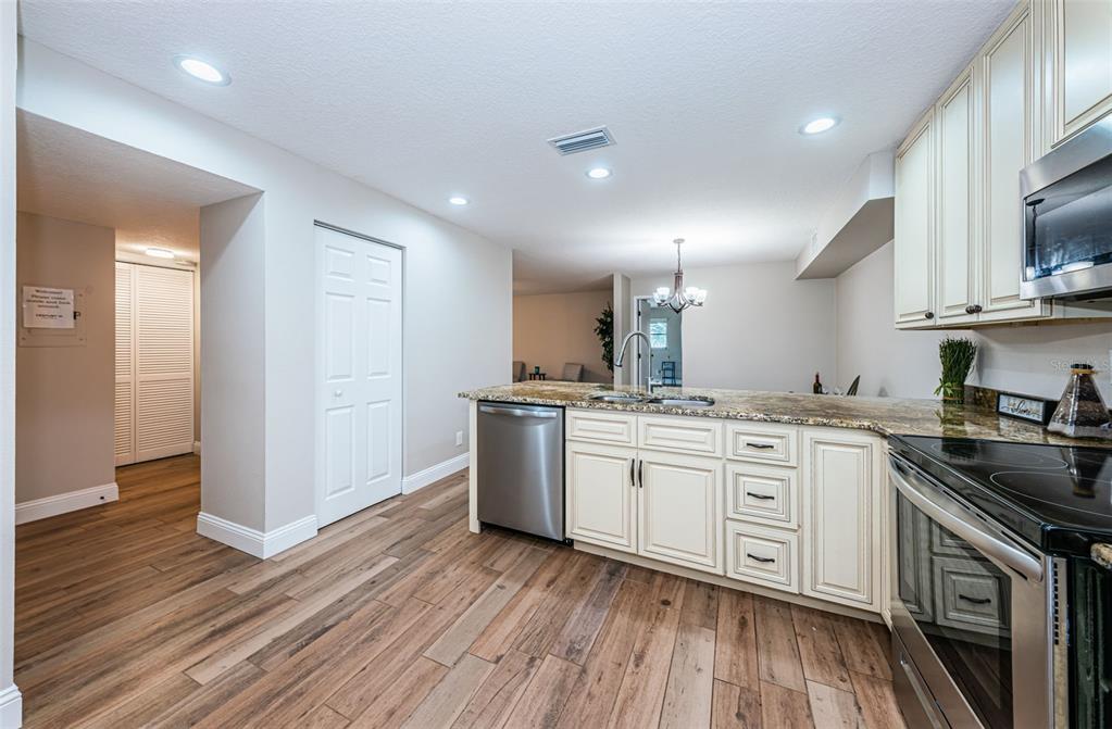 5157 Silent Loop, Unit 301 New Port Richey, FL 34652 - Photo 27 of 71 a kitchen with a sink stove and cabinets