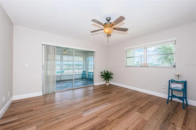 wooden floor in an empty room with a window