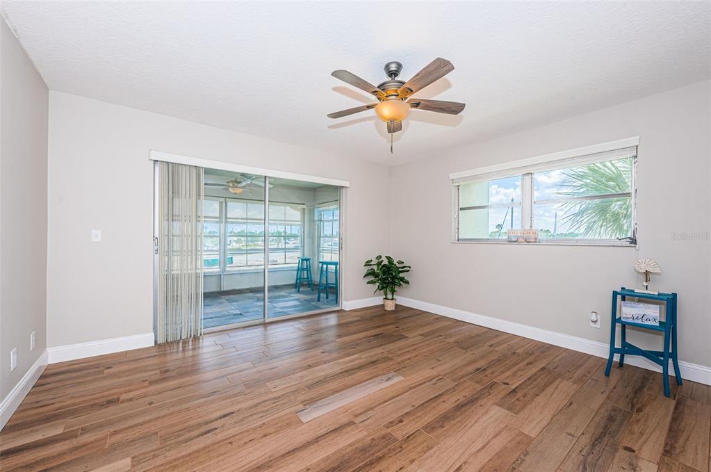 5157 Silent Loop, Unit 301 New Port Richey, FL 34652 - Photo 29 of 71 a view of an empty room with wooden floor and a window