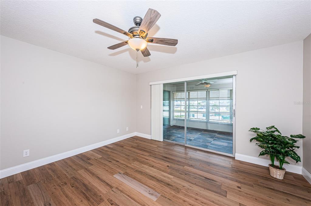 5157 Silent Loop, Unit 301 New Port Richey, FL 34652 - Photo 30 of 71 an empty room with wooden floor and windows