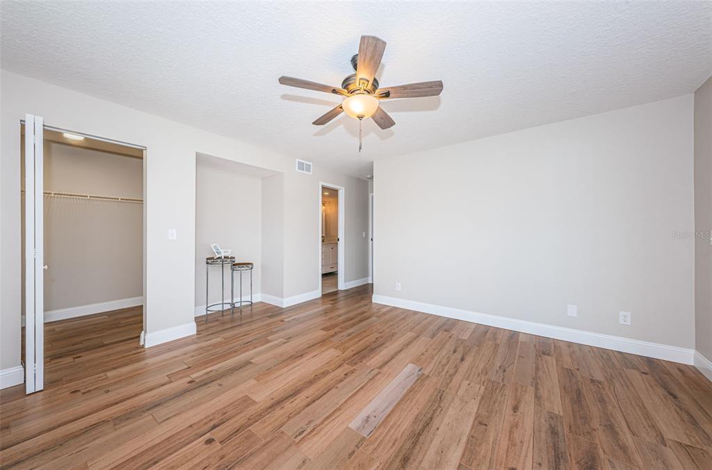 5157 Silent Loop, Unit 301 New Port Richey, FL 34652 - Photo 31 of 71 a view of a room with wooden floor and ceiling fan