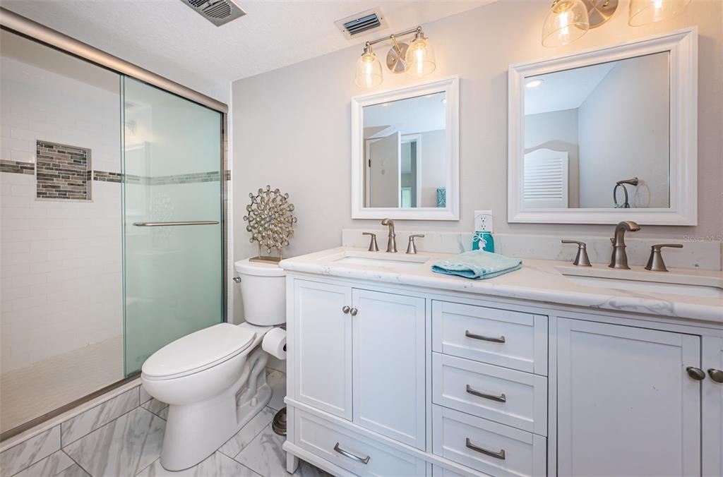 5157 Silent Loop, Unit 301 New Port Richey, FL 34652 - Photo 33 of 71 a bathroom with a granite countertop sink toilet and shower