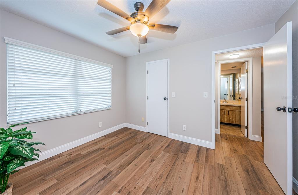 5157 Silent Loop, Unit 301 New Port Richey, FL 34652 - Photo 37 of 71 wooden floor in an empty room with a window