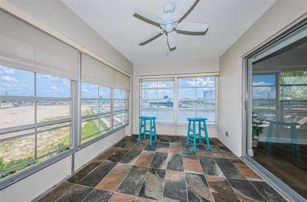 5157 Silent Loop, Unit 301 New Port Richey, FL 34652 - Photo 40 of 71 a room with a rug a rug and a floor to ceiling window