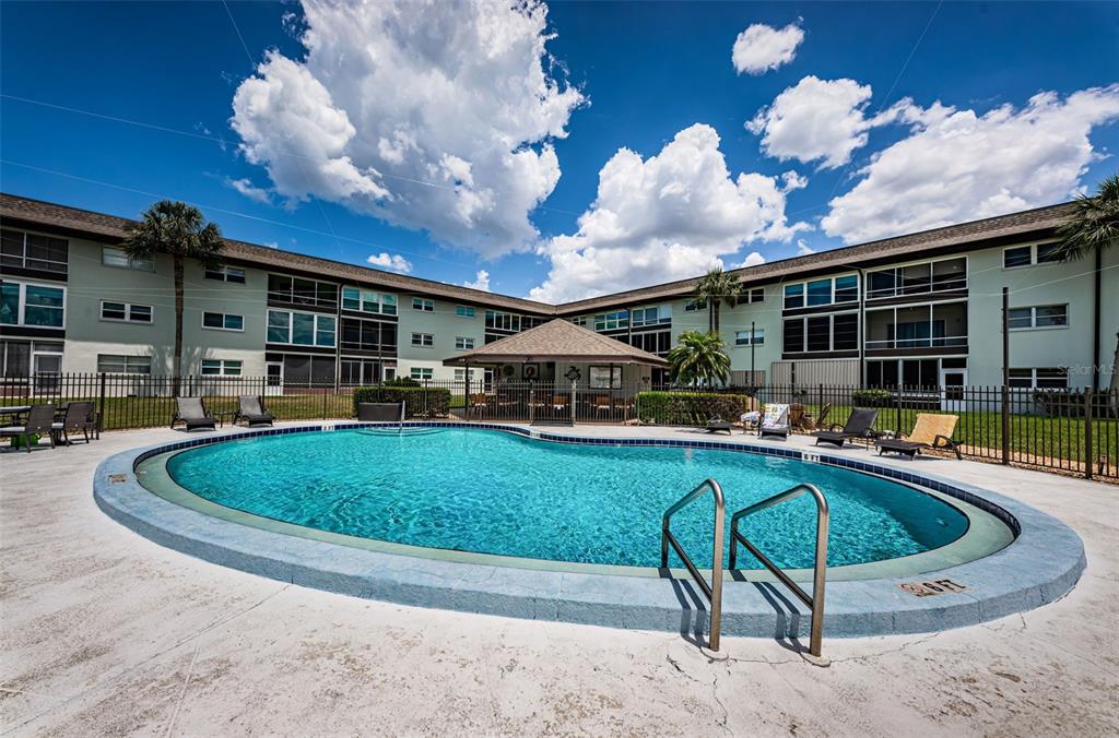 5157 Silent Loop, Unit 301 New Port Richey, FL 34652 - Photo 62 of 71 a swimming pool with outdoor seating yard and barbeque oven