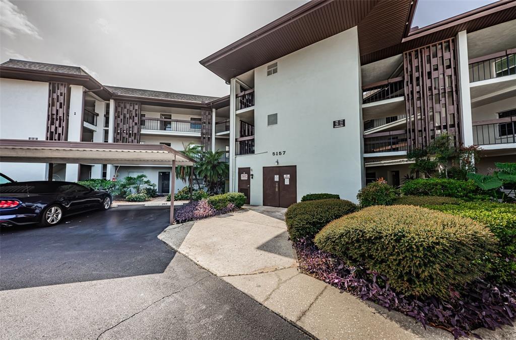 5157 Silent Loop, Unit 301 New Port Richey, FL 34652 - Photo 8 of 71 a view of a car park in front of house