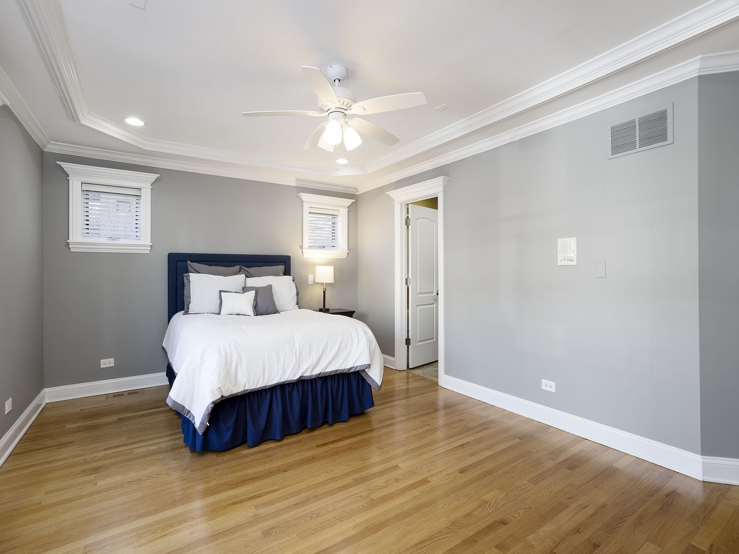 910 West Roscoe Street, Unit 1 Chicago, IL 60657 - Photo 11 of 13 a bedroom with a bed and wooden floor