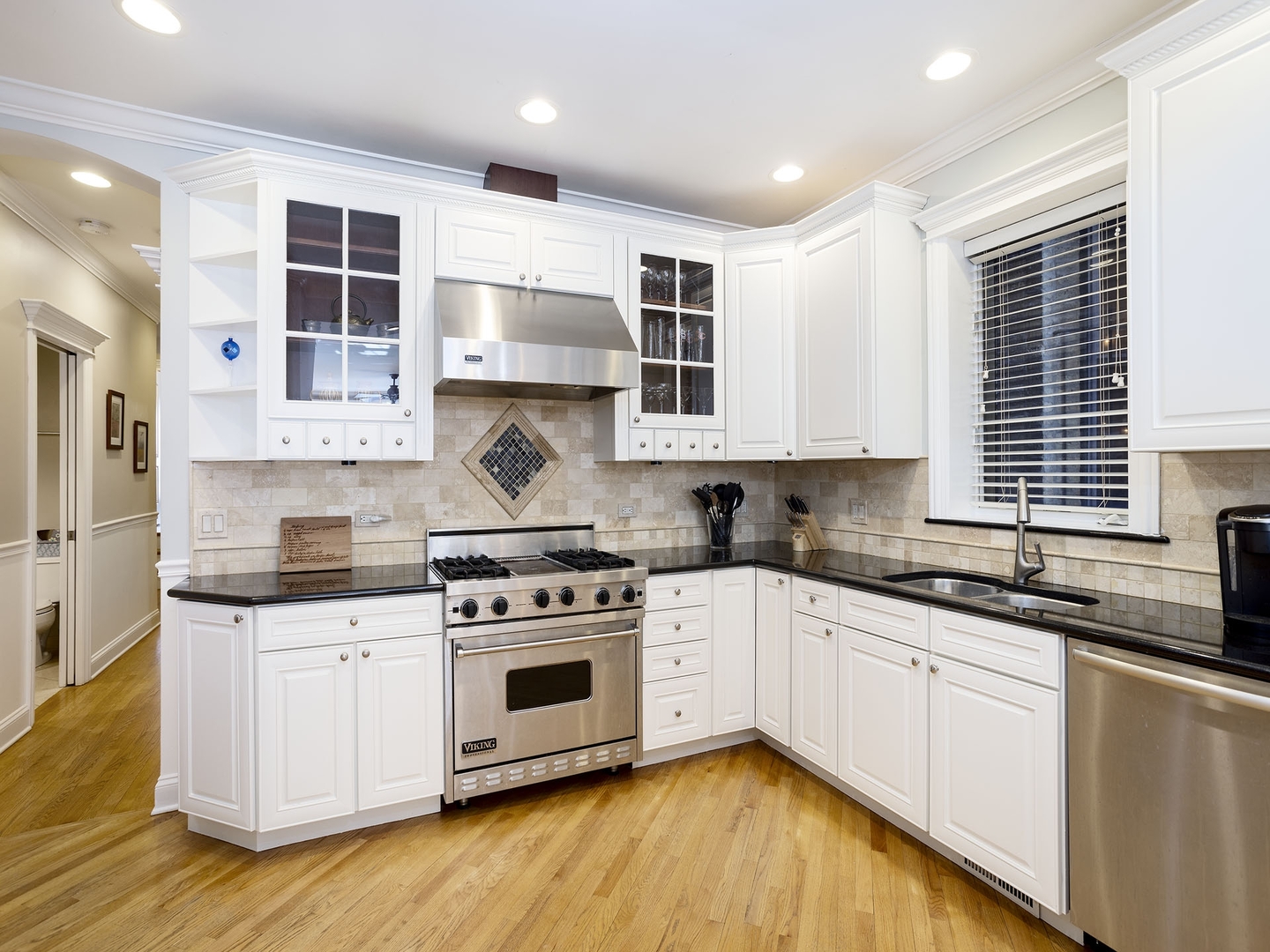 910 West Roscoe Street, Unit 1 Chicago, IL 60657 - Photo 7 of 13 a kitchen with stainless steel appliances granite countertop a stove and a sink
