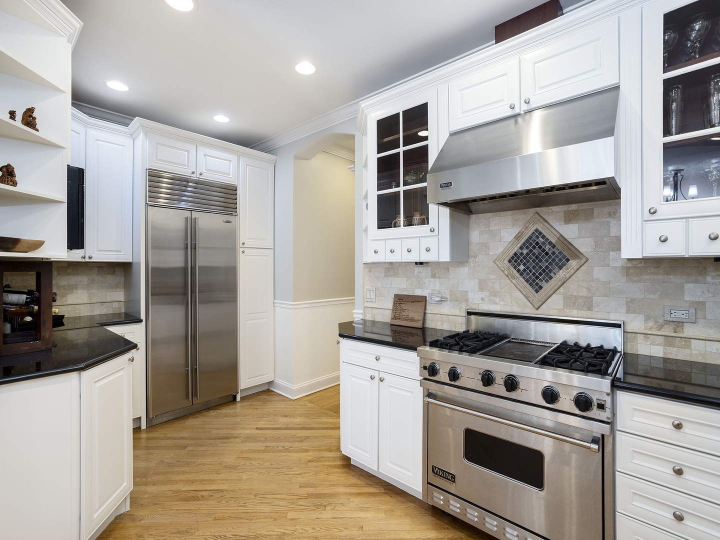 910 West Roscoe Street, Unit 1 Chicago, IL 60657 - Photo 8 of 13 a kitchen with stainless steel appliances a stove a refrigerator and cabinets