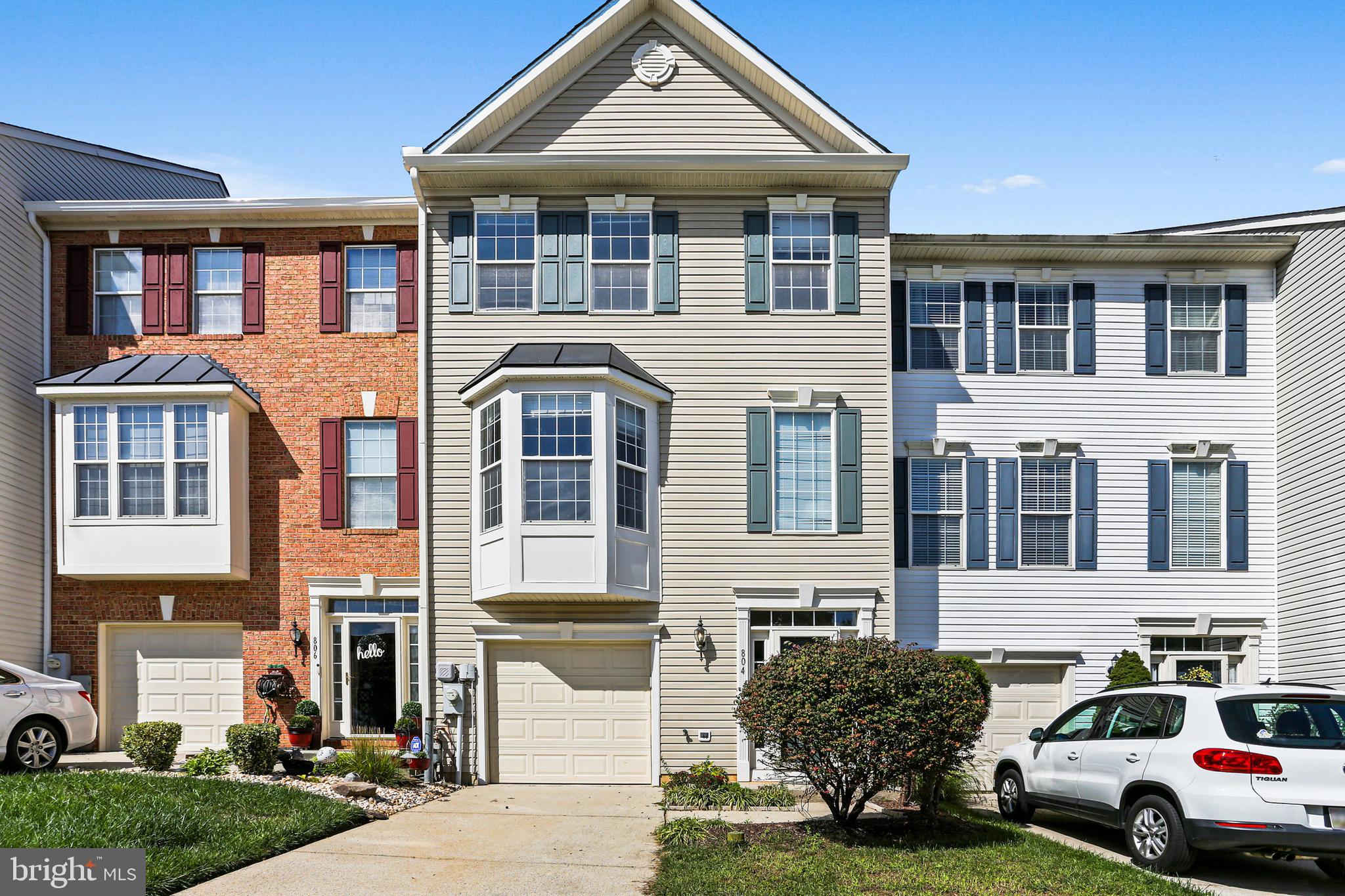 a front view of a residential apartment building with a yard