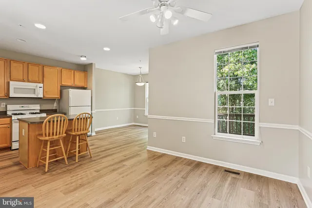 a view of a kitchen with wooden floor and windows