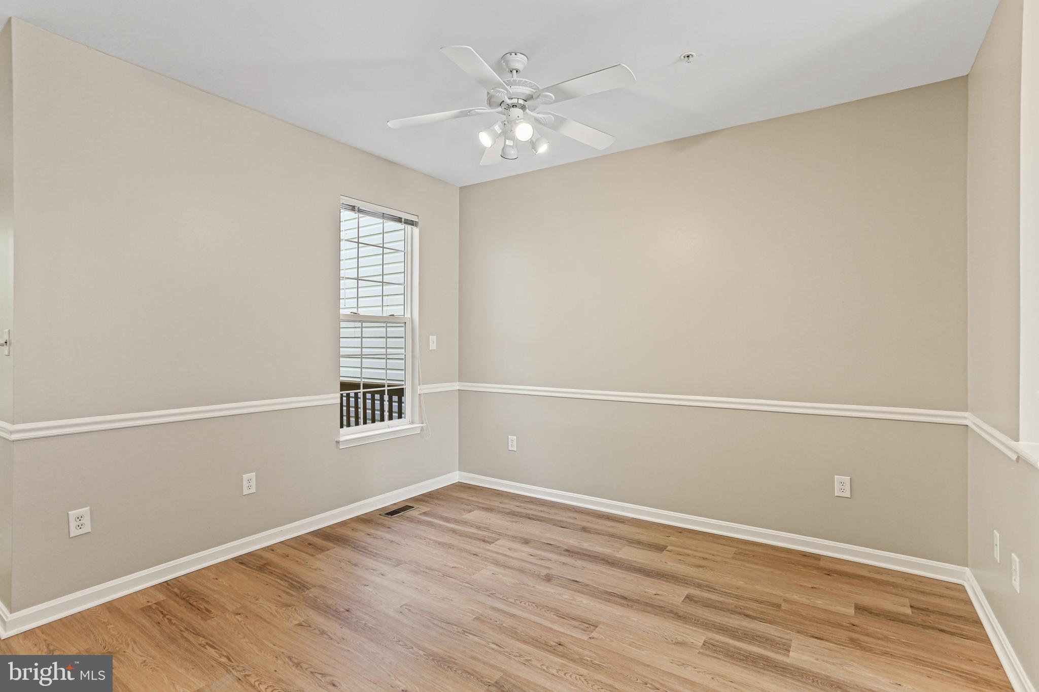 804 Patuxent Run Circle Odenton, MD 21113 - Photo 15 of 29 an empty room with a window and a ceiling fan