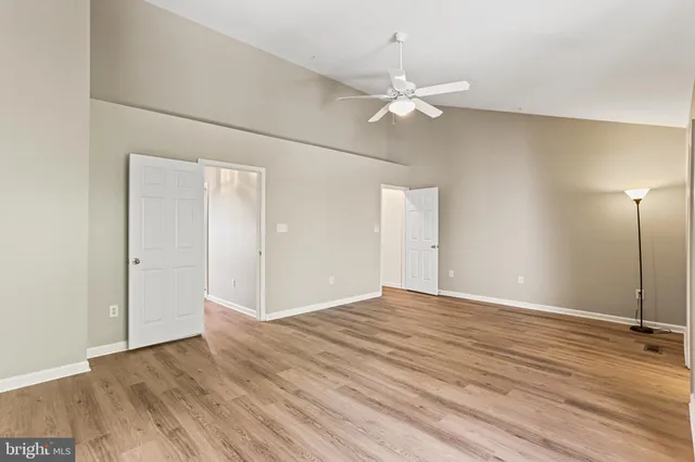 a view of an empty room with wooden floor