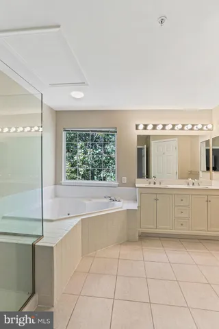 a large bathroom with a large tub and sink