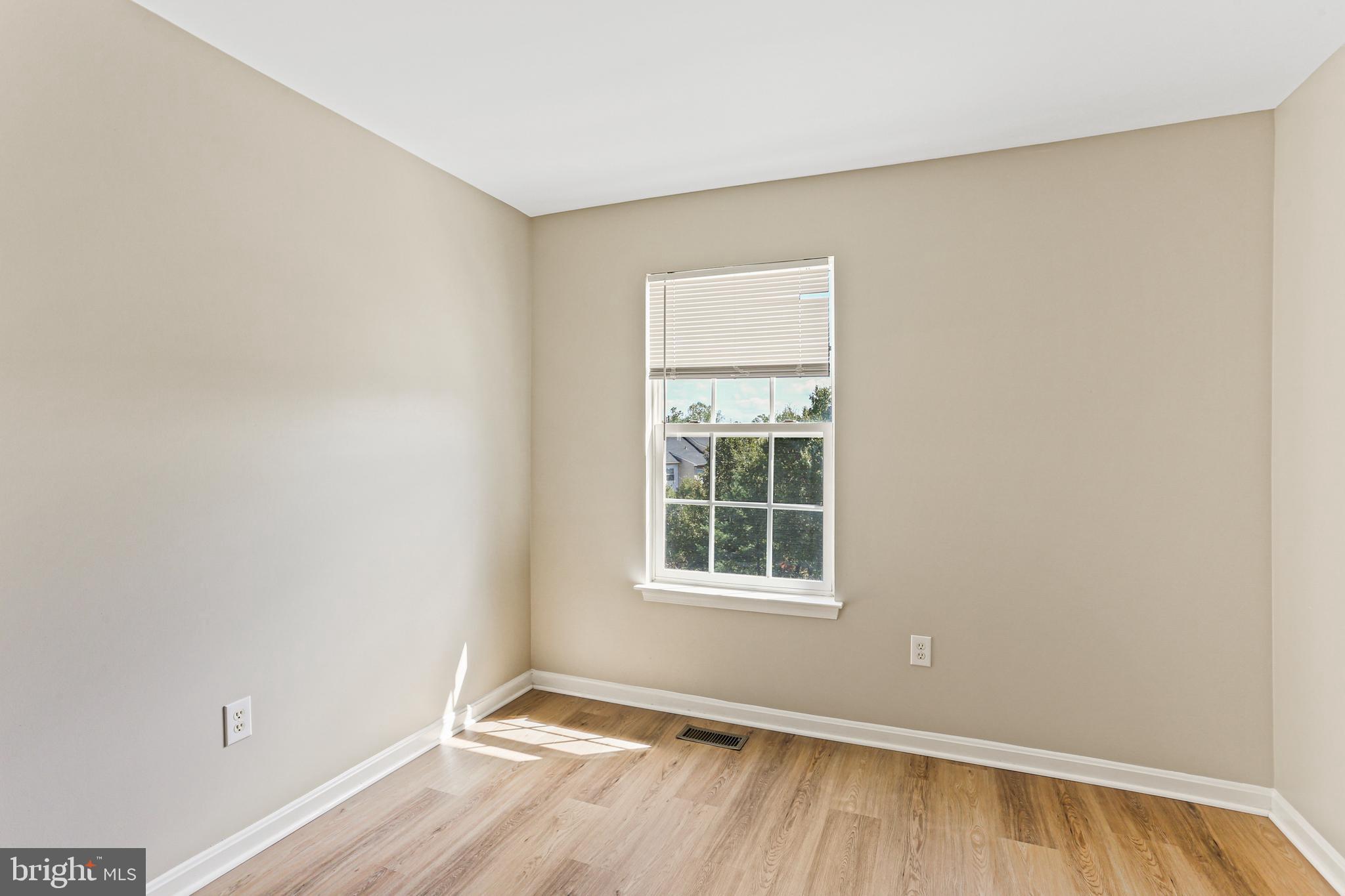 804 Patuxent Run Circle Odenton, MD 21113 - Photo 22 of 29 an empty room with wooden floor and windows