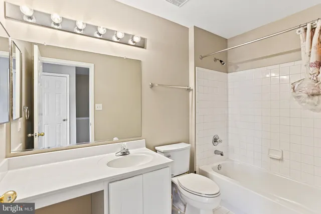 a bathroom with a sink toilet vanity and shower