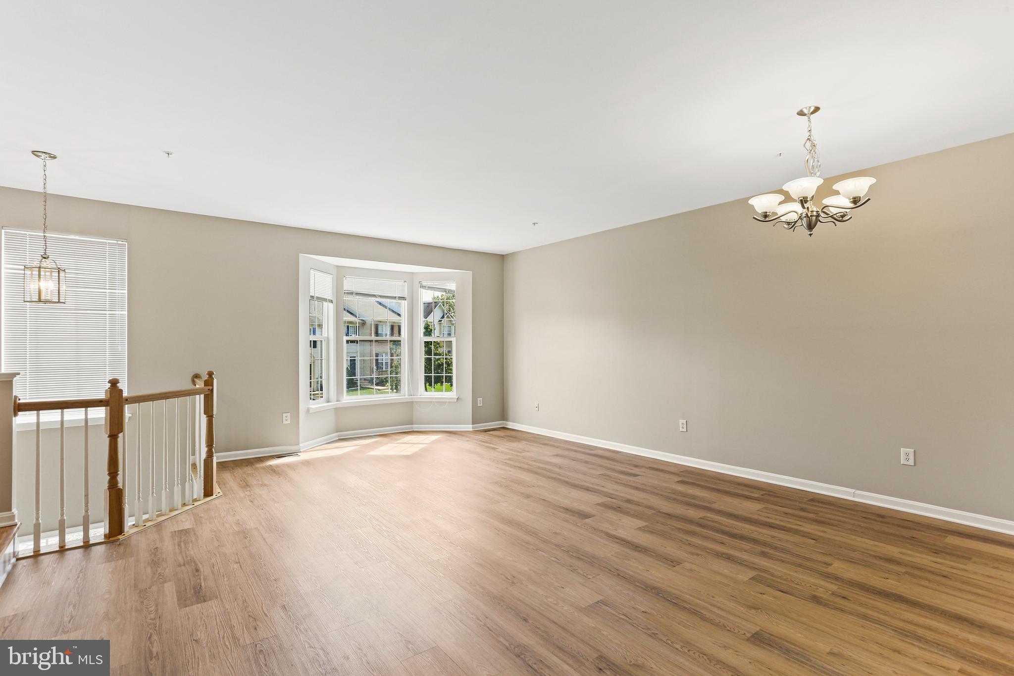 804 Patuxent Run Circle Odenton, MD 21113 - Photo 8 of 29 a view of an empty room with wooden floor and a window