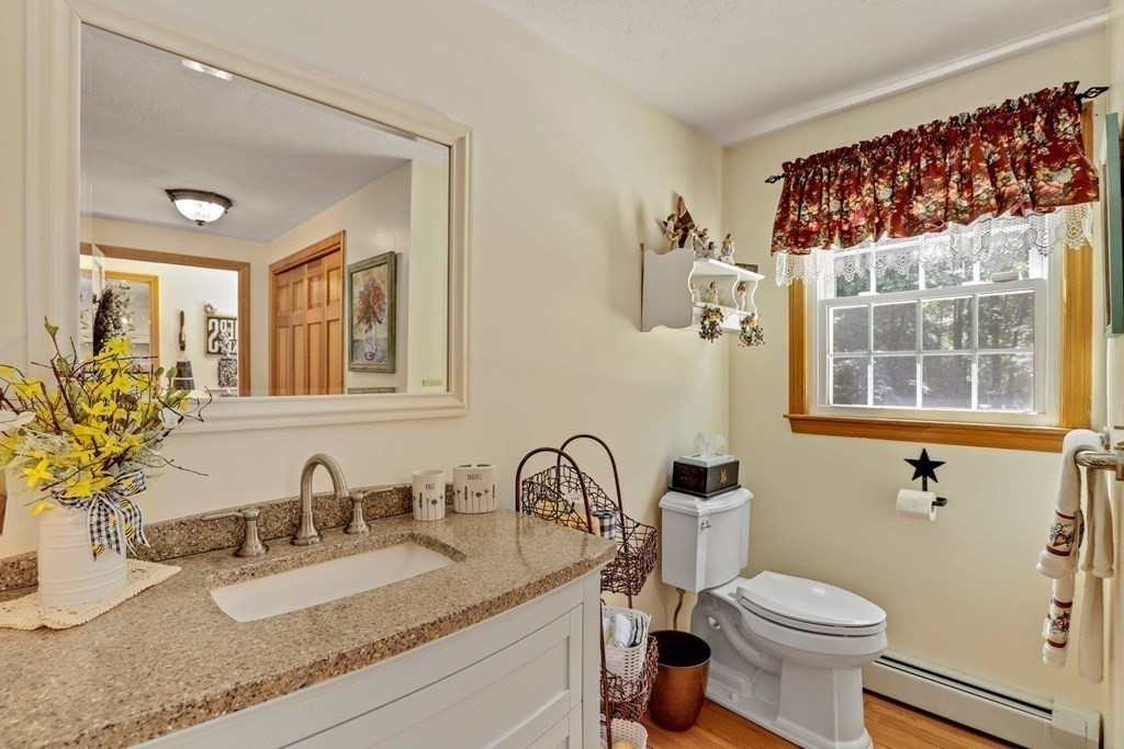 10 Quail Run Road Bellingham, MA 02019 - Photo 16 of 40 a bathroom with a granite countertop toilet sink and mirror