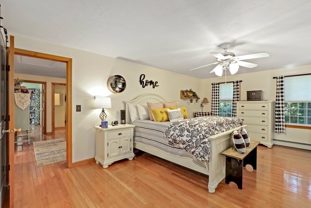 10 Quail Run Road Bellingham, MA 02019 - Photo 17 of 40 a bedroom with a bed and wooden floor