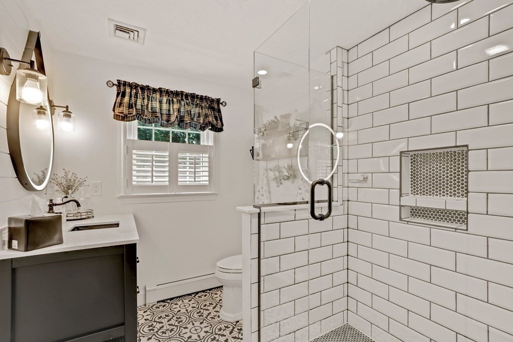 10 Quail Run Road Bellingham, MA 02019 - Photo 21 of 40 a bathroom with a shower a sink and mirror