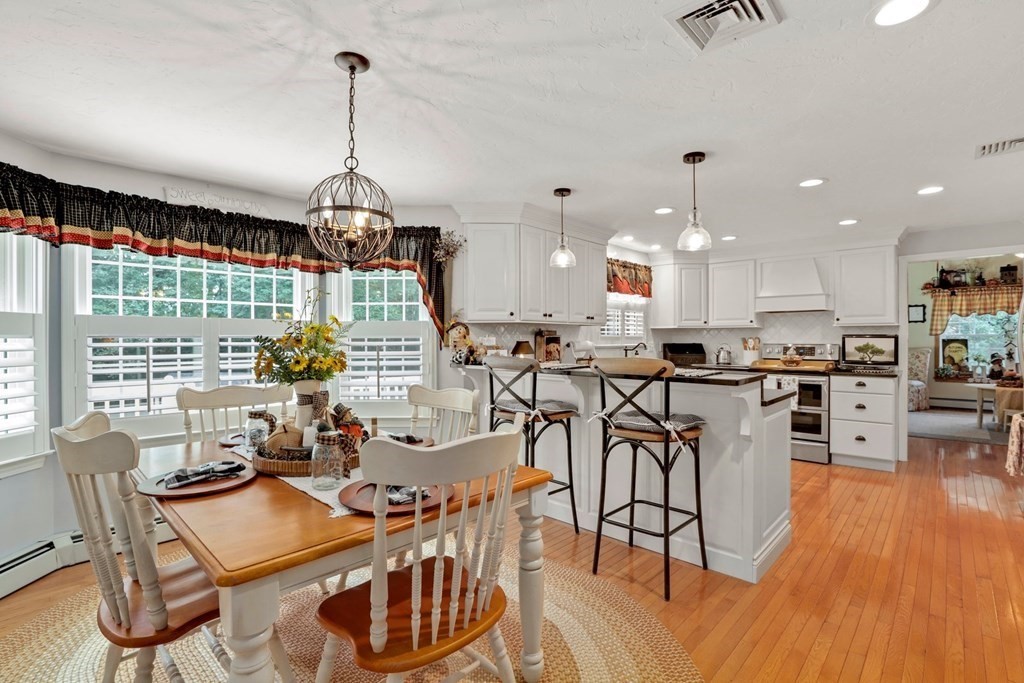 10 Quail Run Road Bellingham, MA 02019 - Photo 5 of 40 a view of a dining room and livingroom with furniture wooden floor a chandelier