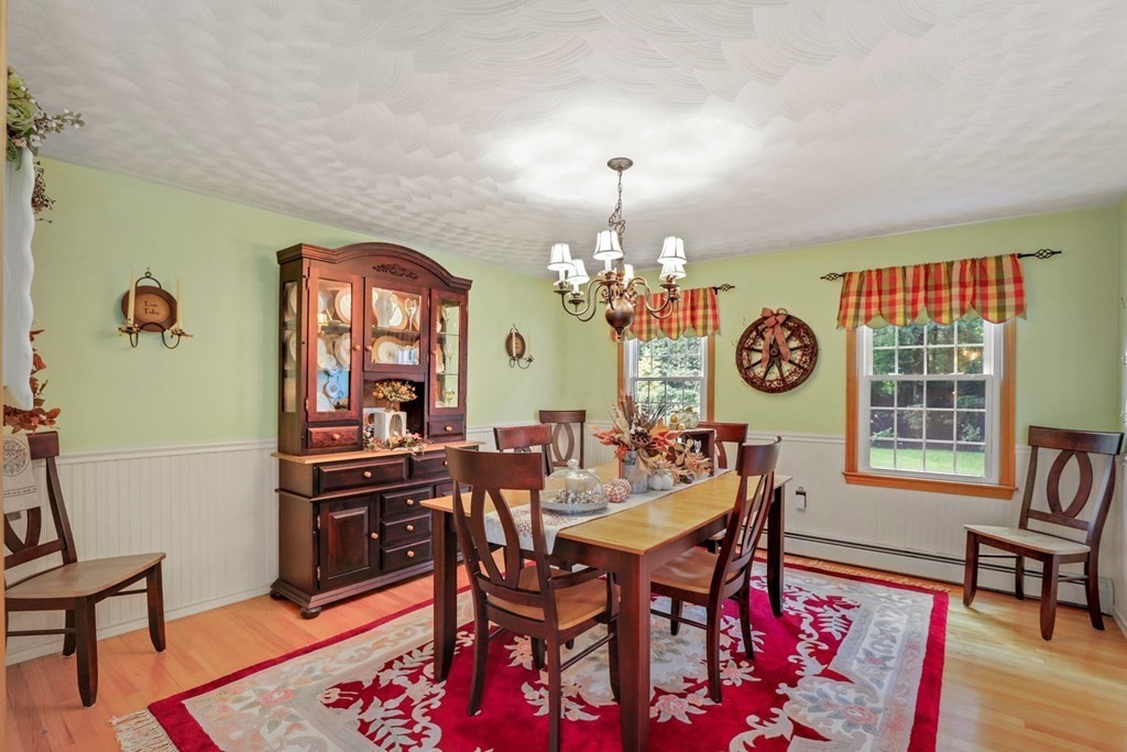 10 Quail Run Road Bellingham, MA 02019 - Photo 6 of 40 a view of a dining room with furniture window and wooden floor