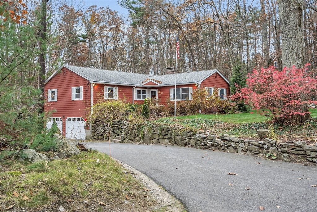 88 Chestnut Road Tyngsboro, MA 01879 - Photo 1 of 42 a front view of a house with a garden