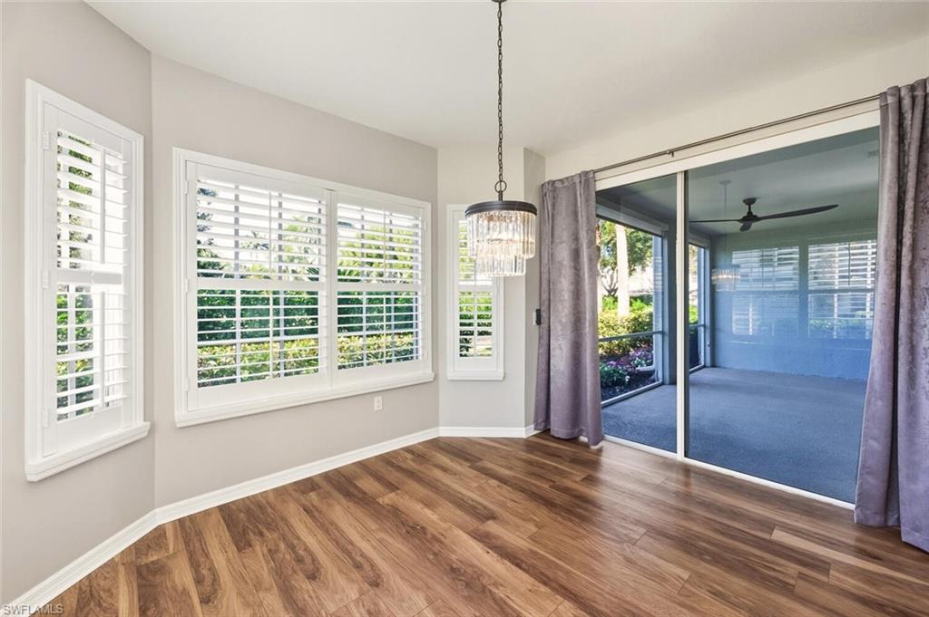 7005 Pinnacle Lane, Unit 1501 Naples, FL 34110 - Photo 14 of 46 a view of room with window and hardwood floor