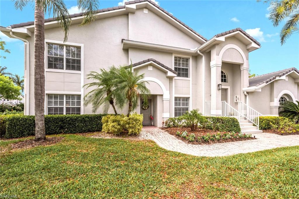 7005 Pinnacle Lane, Unit 1501 Naples, FL 34110 - Photo 2 of 46 a front view of a house with garden