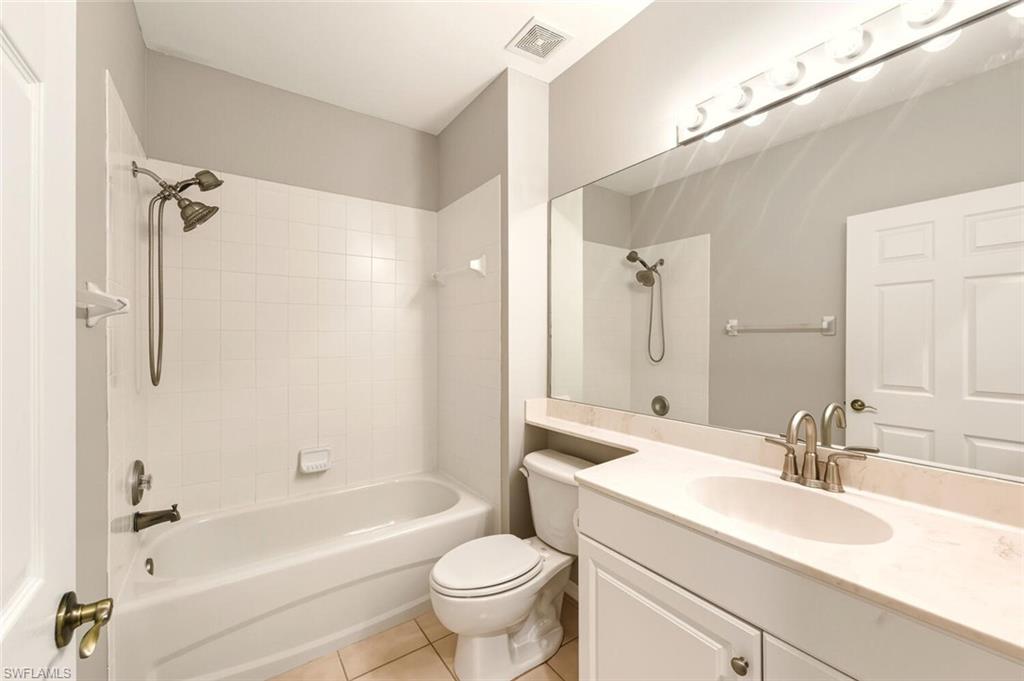 7005 Pinnacle Lane, Unit 1501 Naples, FL 34110 - Photo 23 of 46 a bathroom with a sink a toilet and a bathtub