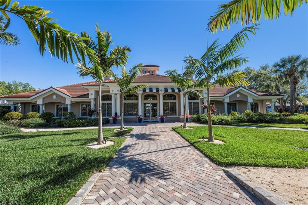 7005 Pinnacle Lane, Unit 1501 Naples, FL 34110 - Photo 36 of 46 a front view of a house with a garden