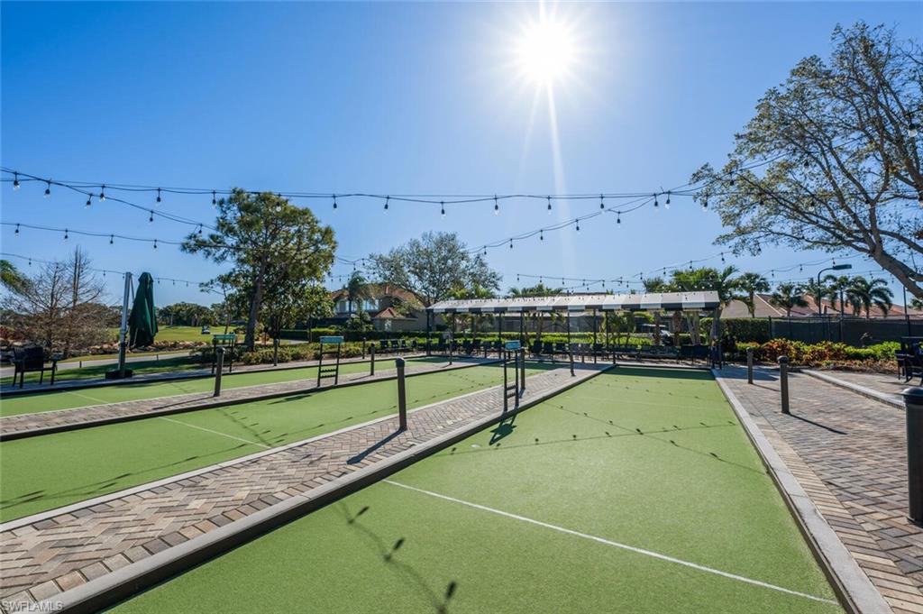 7005 Pinnacle Lane, Unit 1501 Naples, FL 34110 - Photo 40 of 46 a view of an outdoor space and tennis court