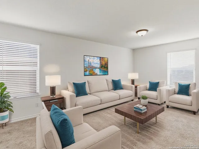 a living room with furniture a rug and a large window