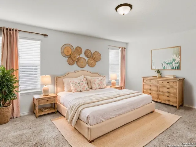 a bedroom with a bed and a potted plant