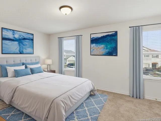 a bedroom with a bed and a painting on the wall