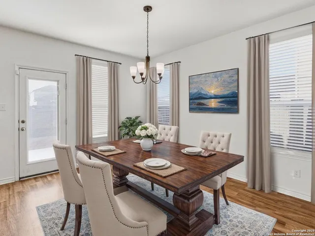 a dining room with furniture a rug and wooden floor