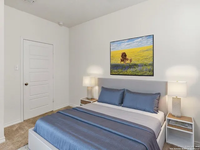 a bedroom with a bed and a painting on the wall