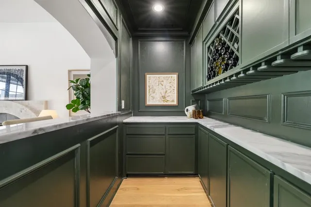 a living room with furniture a fireplace and wooden floor