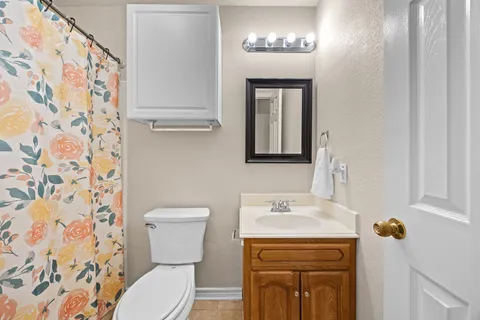 a white bed sitting in a bedroom next to a window