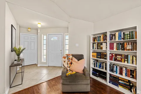 a view of living room with furniture and book shelf