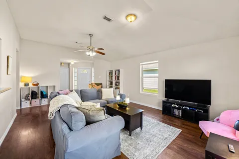 a yellow house with a yard and a large tree