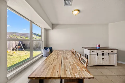 a dining room with furniture and a window