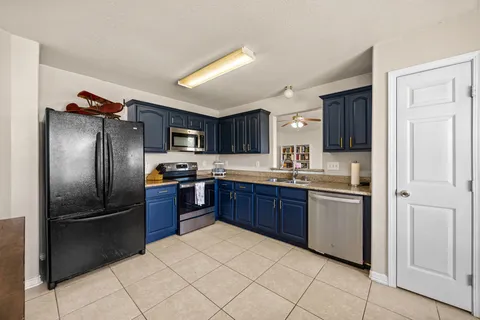 a view of a room with wooden floor and iron stairs
