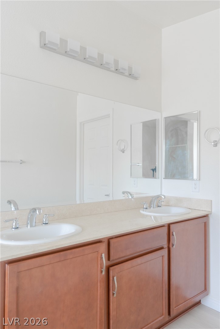8079 Buffalo Ranch Avenue Las Vegas, NV 89147 - Photo 19 of 29 Clean lines and a spacious dual vanity define this bright bathroom space.