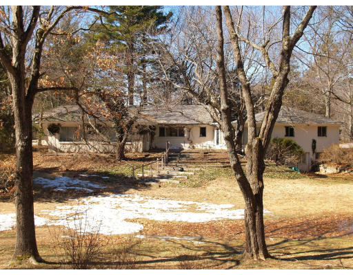 69 Silver Hill Road Lincoln, MA 01773 - Photo 8 of 9 a view of a yard with snow on the road