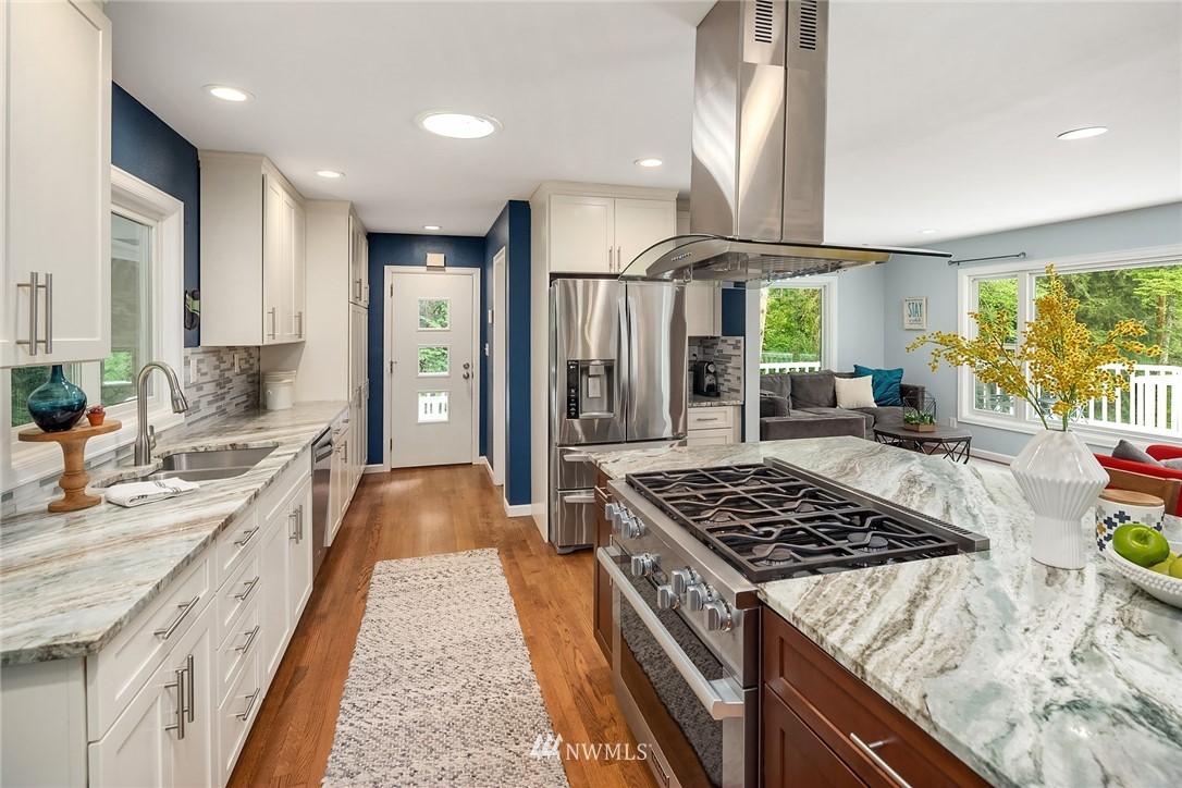 27819 Southeast Issaquah-Fall City Road Fall City, WA 98024 - Photo 13 of 39 a kitchen with stainless steel appliances granite countertop a stove a sink dishwasher and a refrigerator