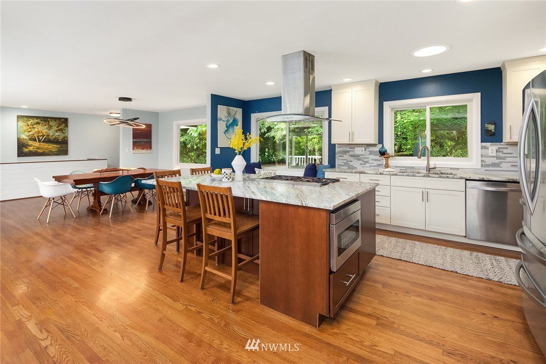 27819 Southeast Issaquah-Fall City Road Fall City, WA 98024 - Photo 15 of 39 a kitchen with stainless steel appliances granite countertop sink stove and wooden cabinets