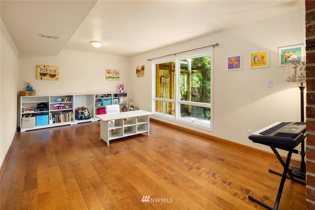27819 Southeast Issaquah-Fall City Road Fall City, WA 98024 - Photo 29 of 39 a living room with furniture and a flat screen tv